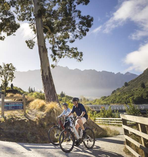People biking with mountain in the background