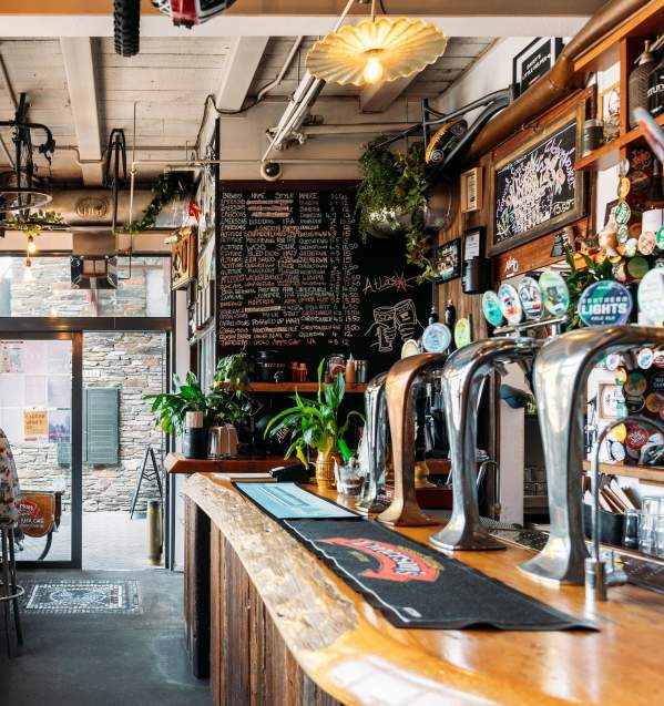 Inside view of Atlas Beer Café with person sitting a high table drinking beer