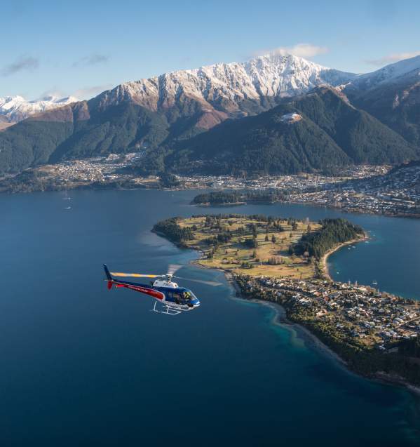 Helicopter flying over Queenstown Lake