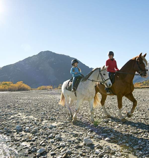 Young girl and mum riding horses in Glenorchy