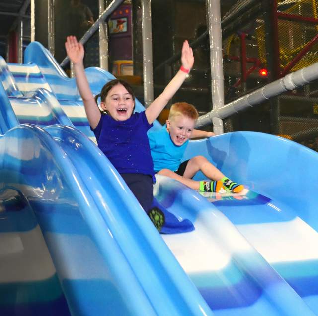 Kids On A Slide At Uptown Jungle Fun Park In Chandler, AZ