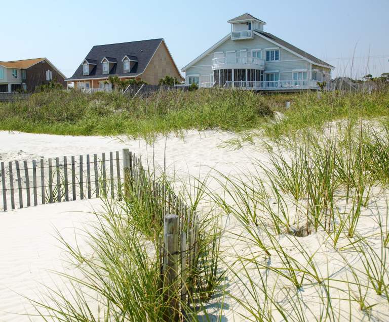 Beach houses sit behind sand dunes in North Myrtle Beach