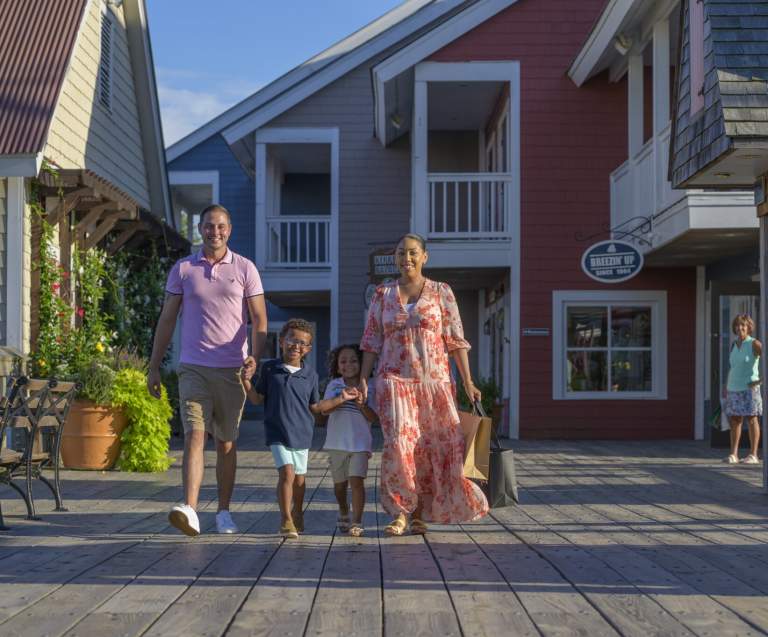 a family taking a stroll at Barefoot Landing