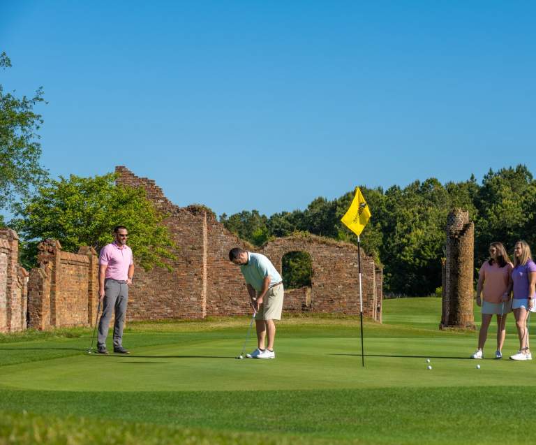 Golfers putting at Barefoot Resort