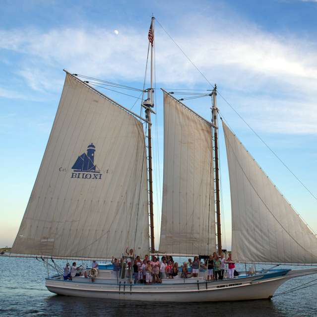 A Biloxi Schooner sails on the Mississippi Sound at sunset