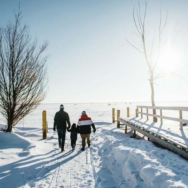 family walking on snow trail
