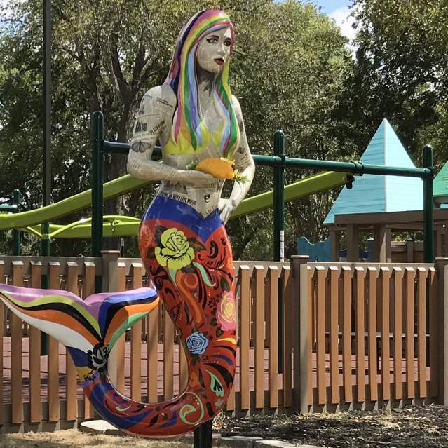 10 foot tall painted mermaid statue with fish taco in hand