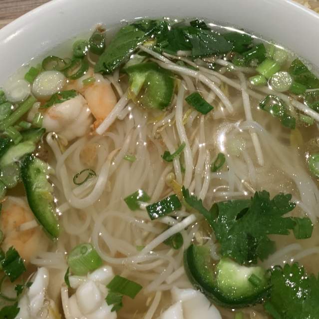 Pho bowl with noodles, shrimp and green onions