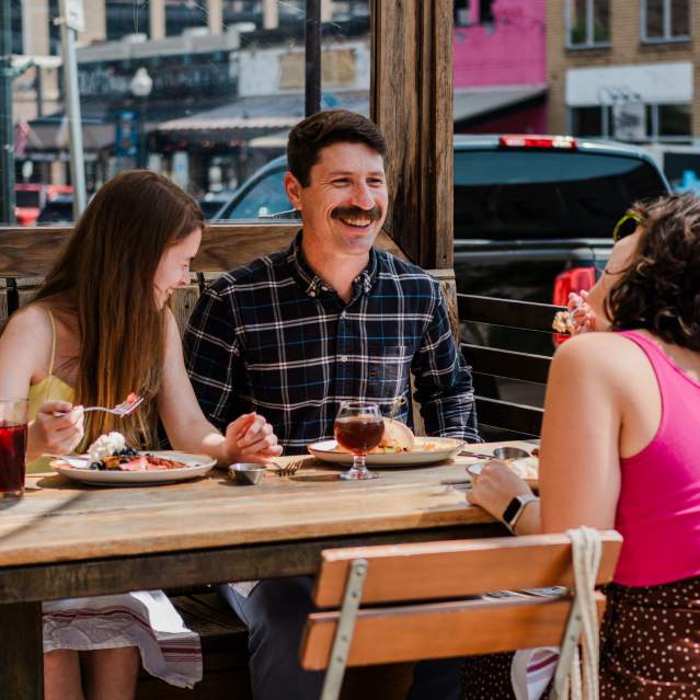 A family of three enjoy a nice leisurely brunch at Root Cellar Cafe in Downtown San Marcos