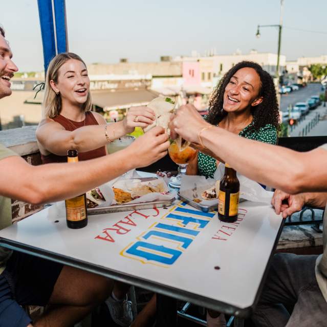 Two couples cheers their tacos at Blind Salamander Cantina in Downtown San Marcos
