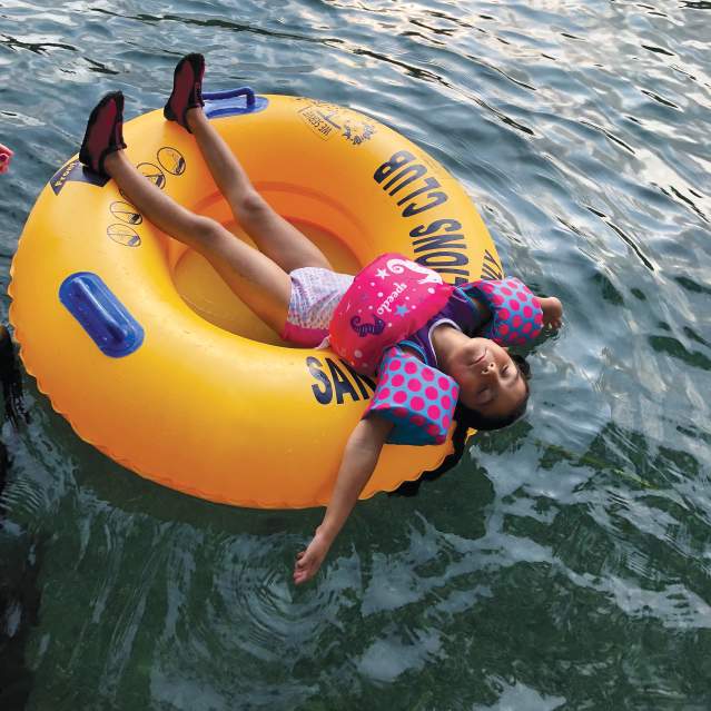 Little girl relaxing and floating on the San Marcos River