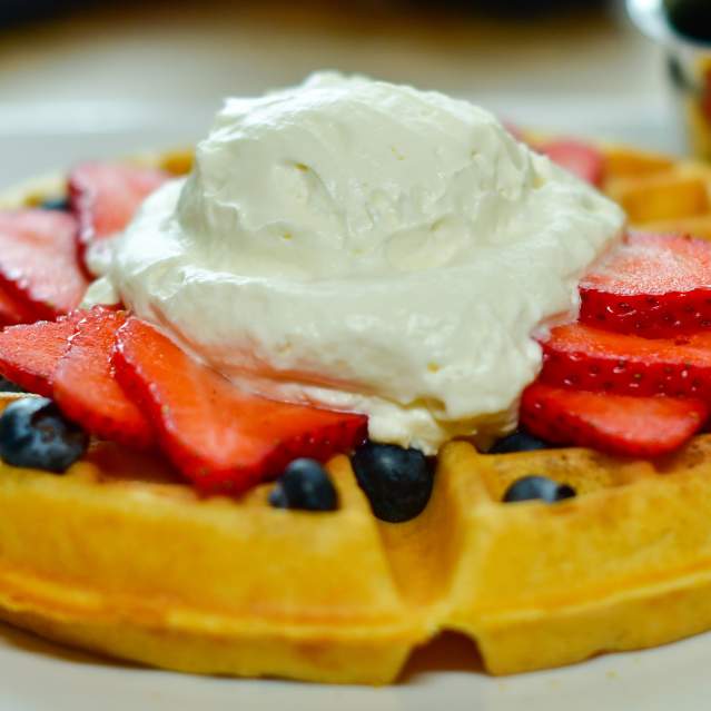 Belgian waffles with fruit and whipped cream