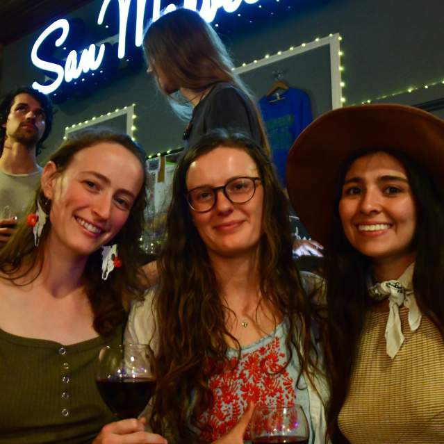 Three women at live music event