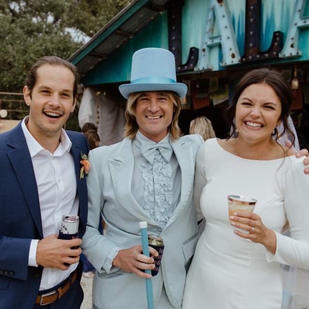 Wedding couple with friend in blue top hat