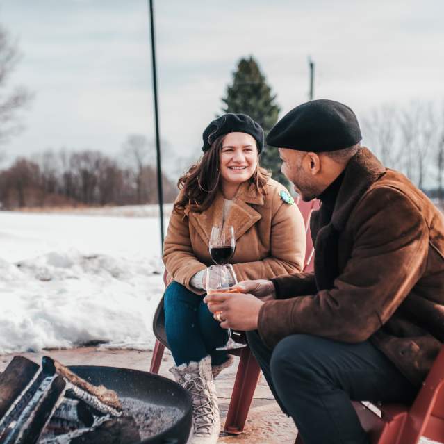 couple by fire at winery
