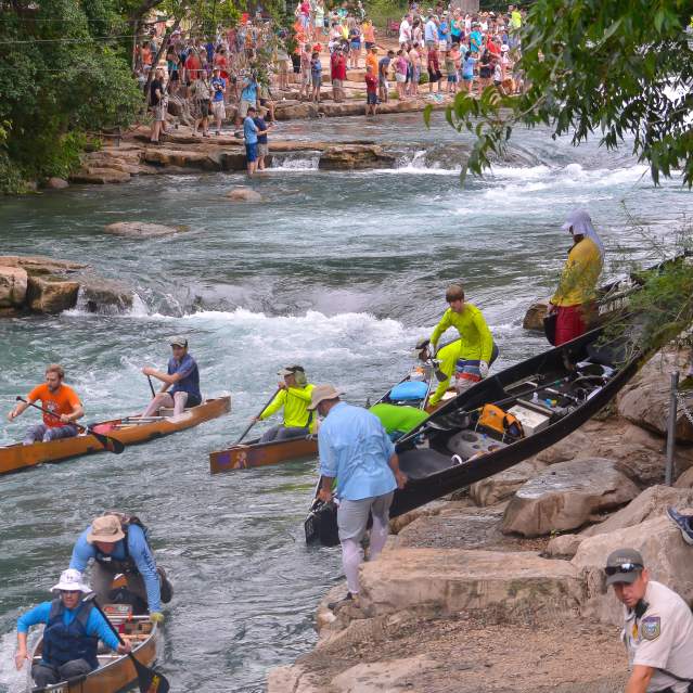 Texas Water Safari kayak racers portage at Rio Vista Falls
