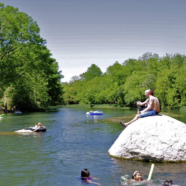 People in park and tubes on the river