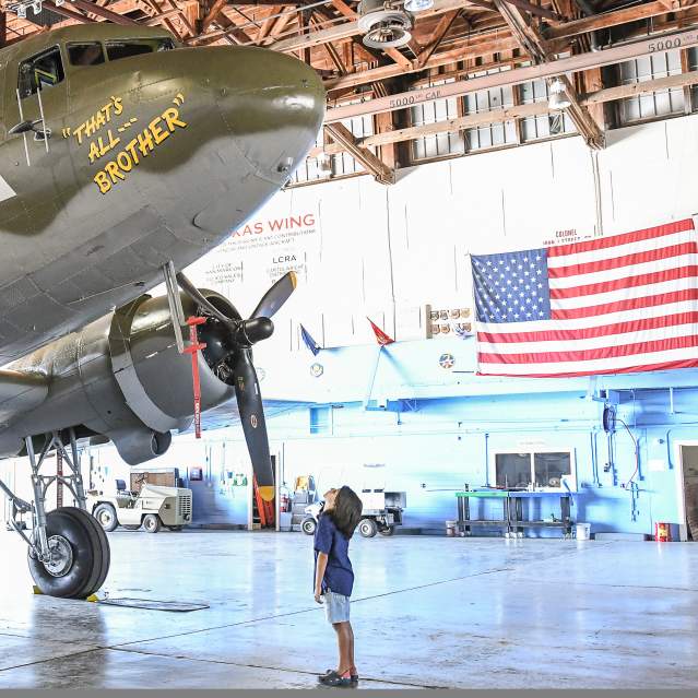 Boy looking up at WWII bomber