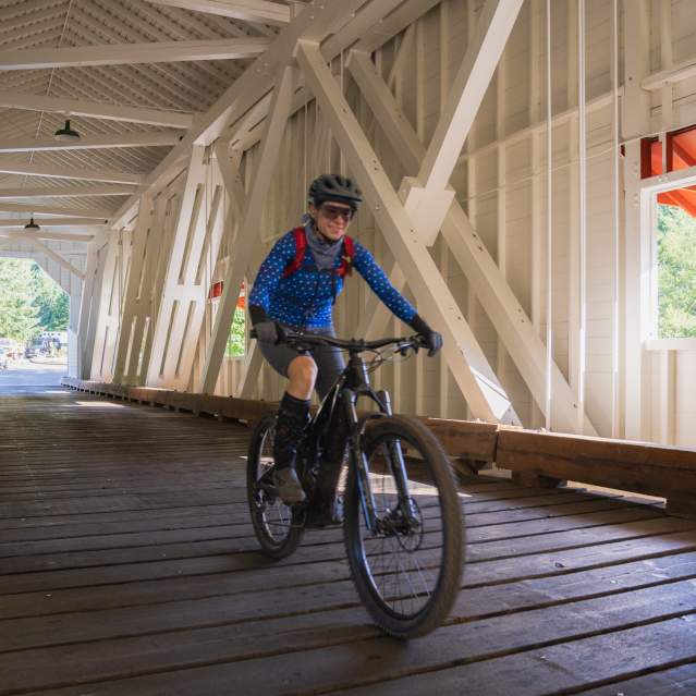 Mountain biking across the Office Bridge in Westfir, Oregon.
