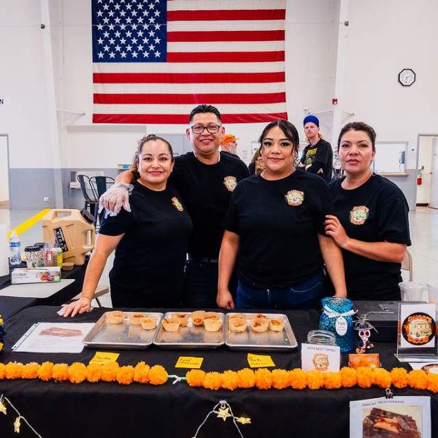 A picture of four people wearing black at the Tamale Festival