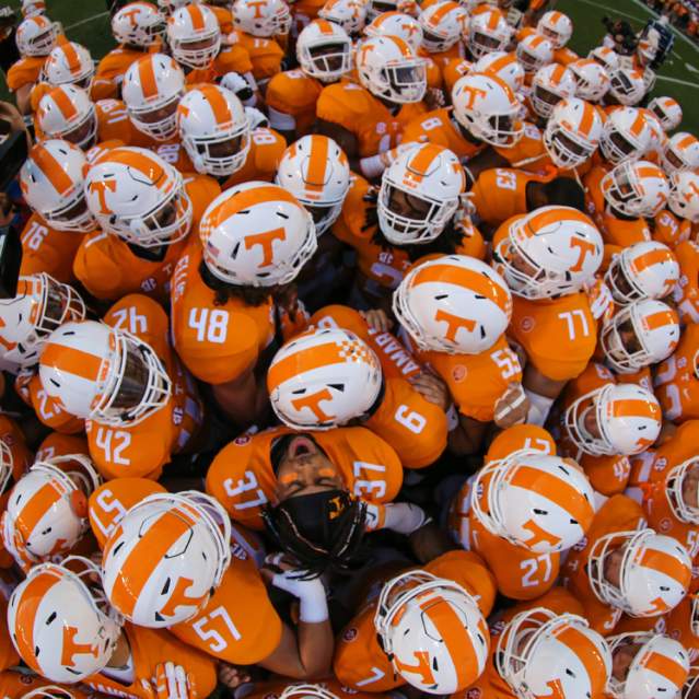 A huddle of players on the University of Tennessee football team