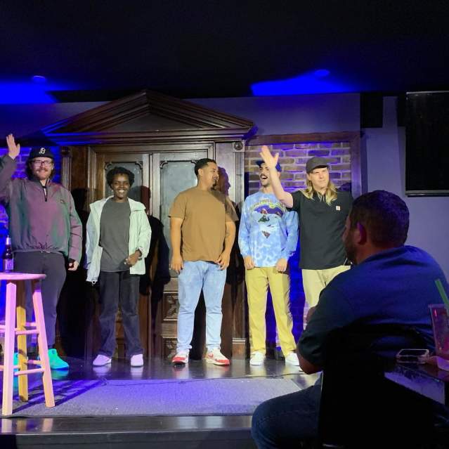 Cincinnati comedians standing on stage at a comedy club