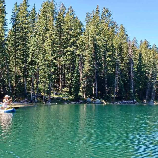 Woman Fly Fishing on a Paddleboard on The Grand Mesa