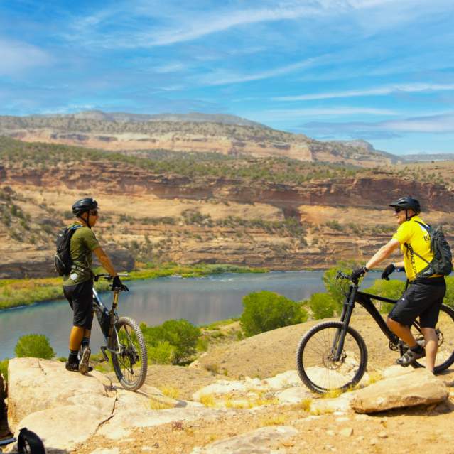 Two mountain bikers overlook the Colorado River