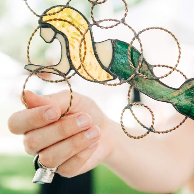 Woman touching stained glass mermaid