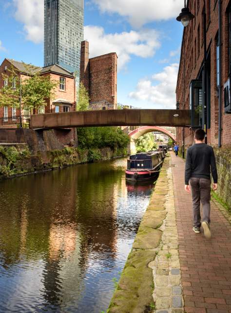 Person walking next to canal in Manchester