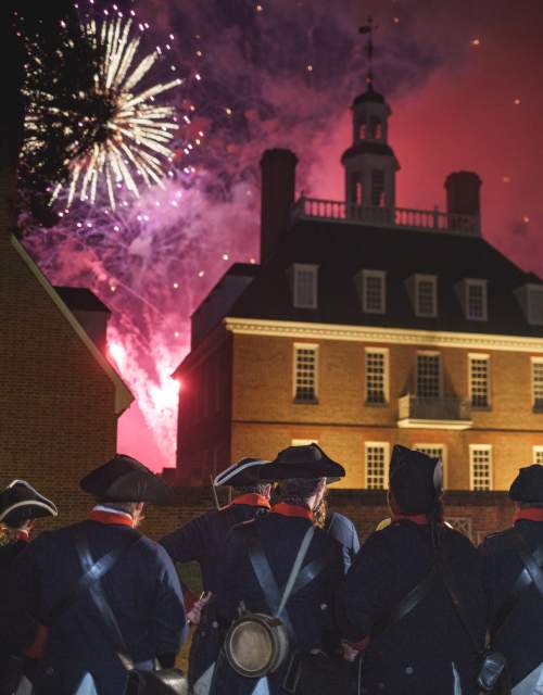 Colonial soldiers watching fireworks go off on the 4th of July
