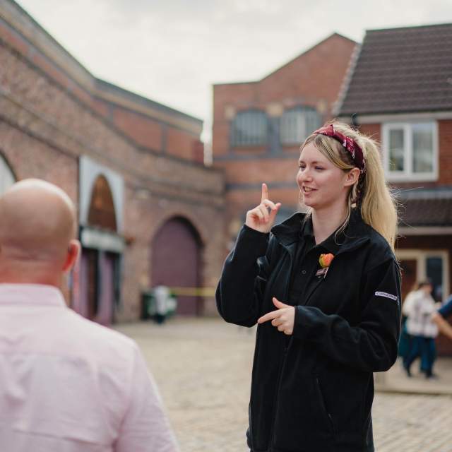Guide on Coronation Street Tour set with visitors