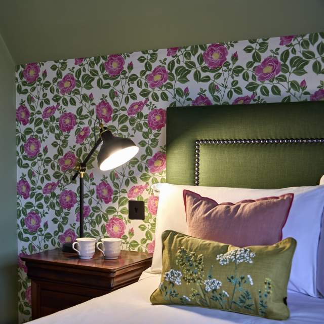 Floral themed hotel room with green accented headboard, Black Horse Climping