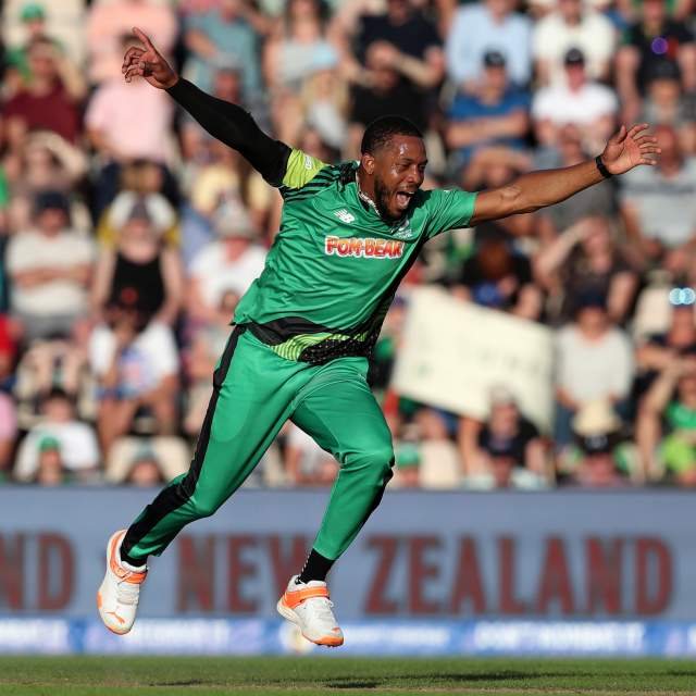 Cricket player jumping for joy on field of The Hundred match