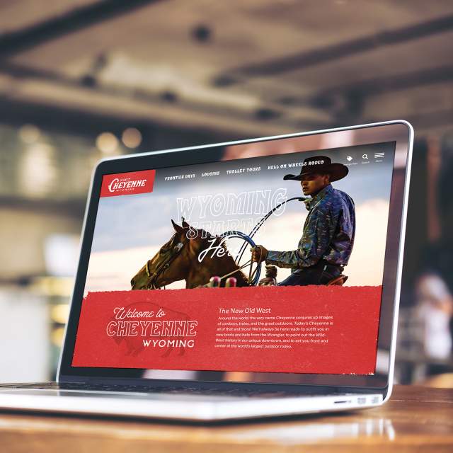 Laptop showcasing the Visit Cheyenne website homepage