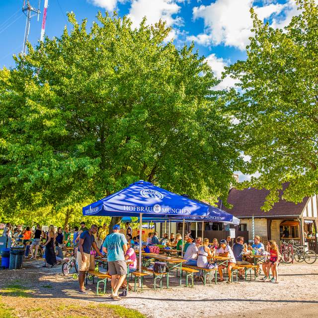 picnic tables filled with people in park