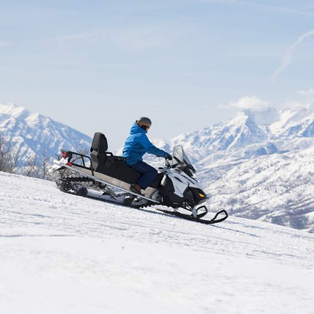 Snowmobile on Ridge with Timpanogos in the background