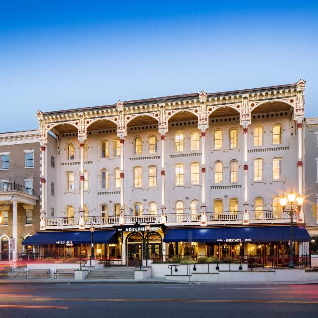 Adelphi Hotel at dusk with lights on