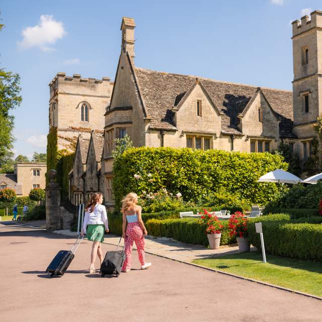 Two women with bags arriving at Ellenborough Park hotel