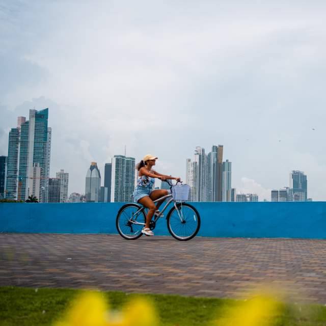 Biking on Cinta Costera, in the background Panama City skyline, Panamá