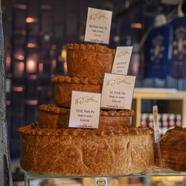 Display of different size pork pies to order in WJ Castle in Burford