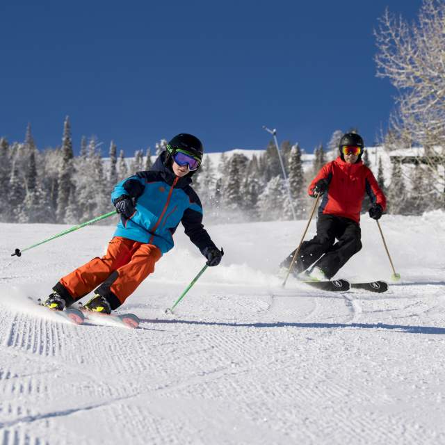 Family skiing on sunny day at Deer Valley Resort