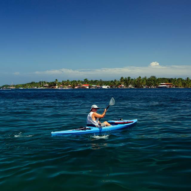 Kayak on blue waters, in the background you can see Carenero Island in Bocas del Toro