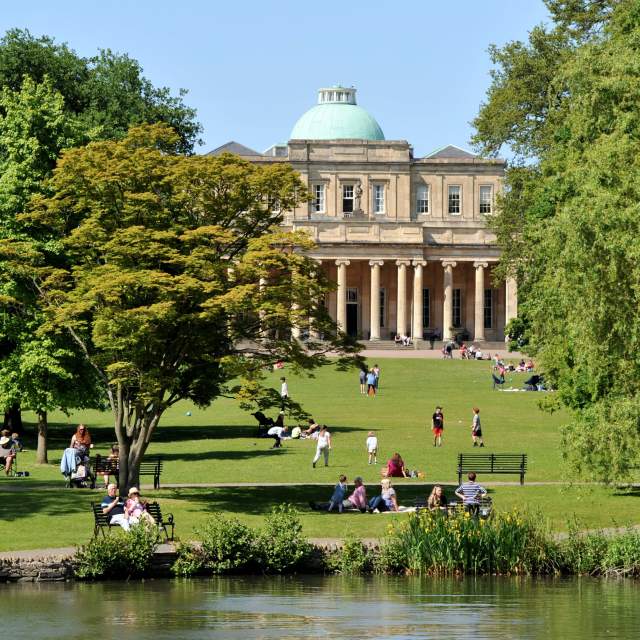 People enjoying the sunshine at Pittville Park Cheltenham in the summer.