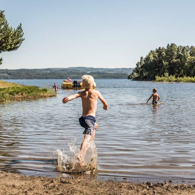 Eager boy running on the beach at Sveastranda Camping