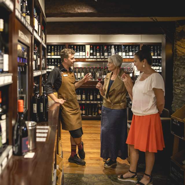 Person tasting wine in The Winery Arrowtown