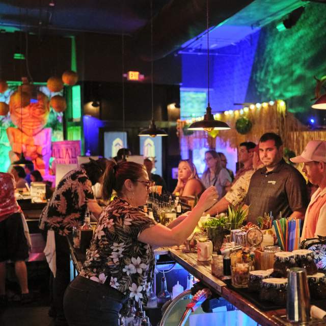 People enjoying tiki themed beverages during Mobile Tiki week at The Haberdasher