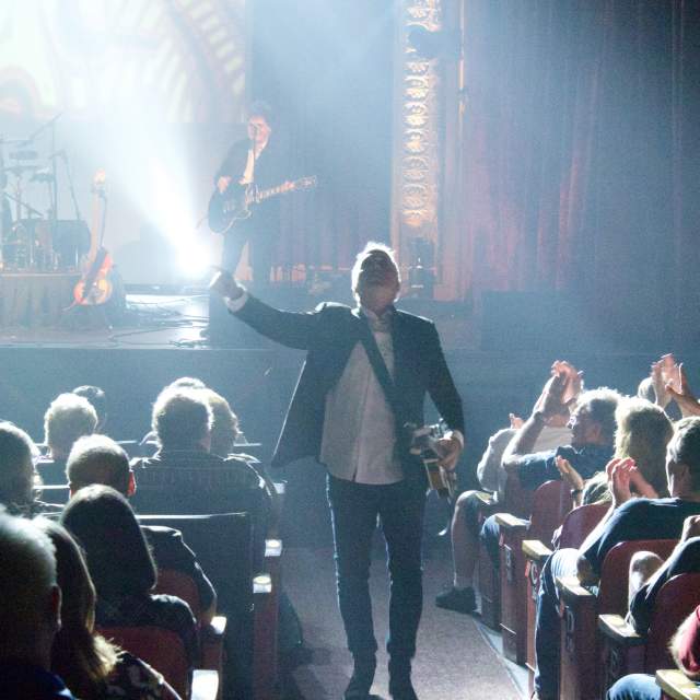 Man performing and walking up an aisle at Mauch Chunk Opera House