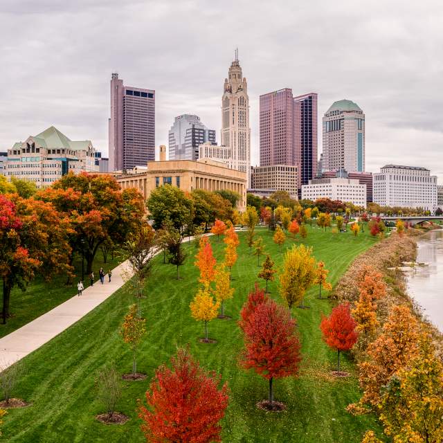 Columbus skyline view from the Scioto River. Fall foliage surrounds the area