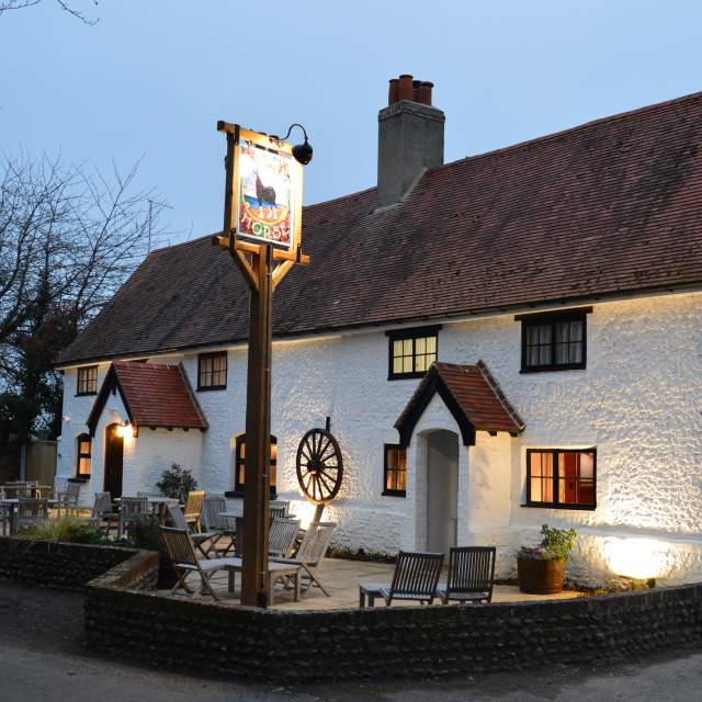 Exterior white facade of the Black Horse pub in Climping, Sussex